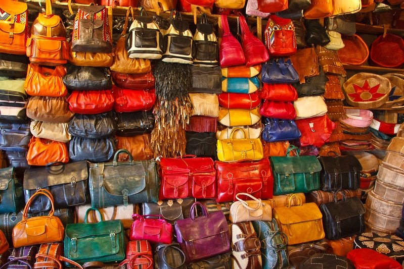 What are the challenges in producing luxury leather goods?