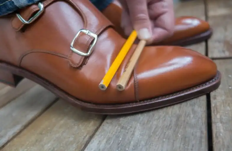 How can one prevent creasing in leather footwear?